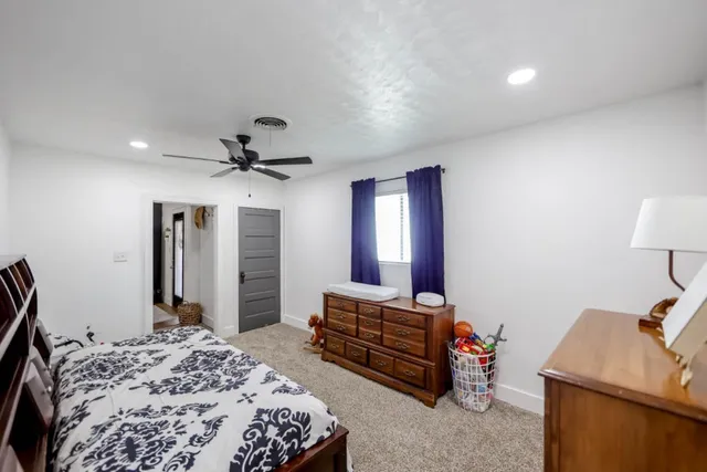 a bedroom with bed and a chandelier
