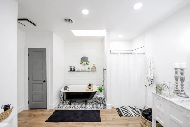 a living room with a couch and a potted plant