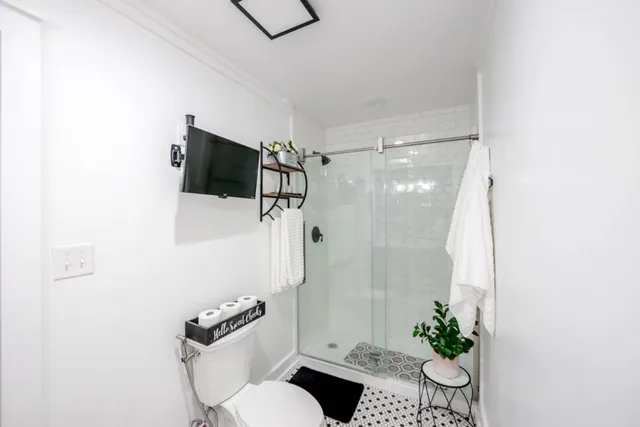 a bathroom with a bathtub and shower