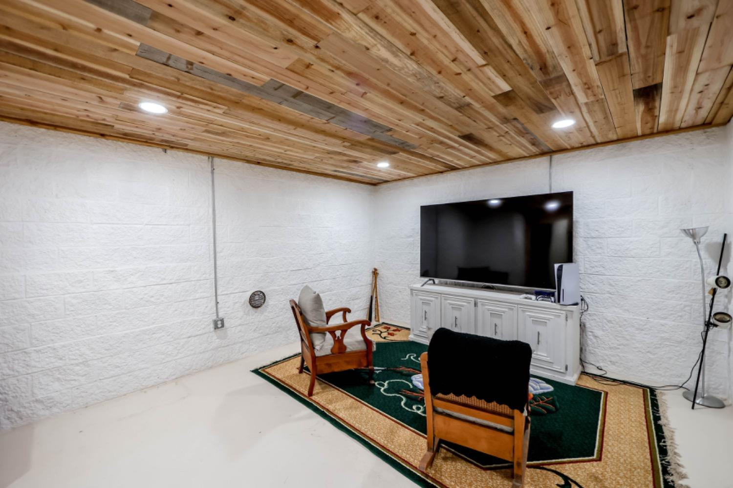 209 D Avenue Abernathy, TX 79311 - Photo 28 of 43 a living room with furniture a flat screen tv and a fireplace