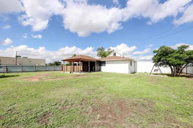 a view of a house with a backyard and garage