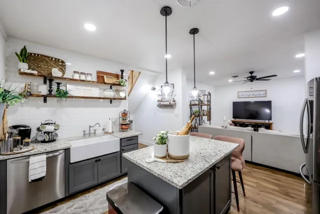a kitchen with a sink a counter and cabinets
