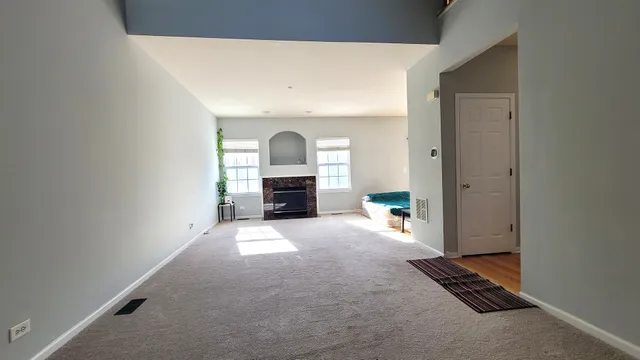 a view of empty room with a fireplace