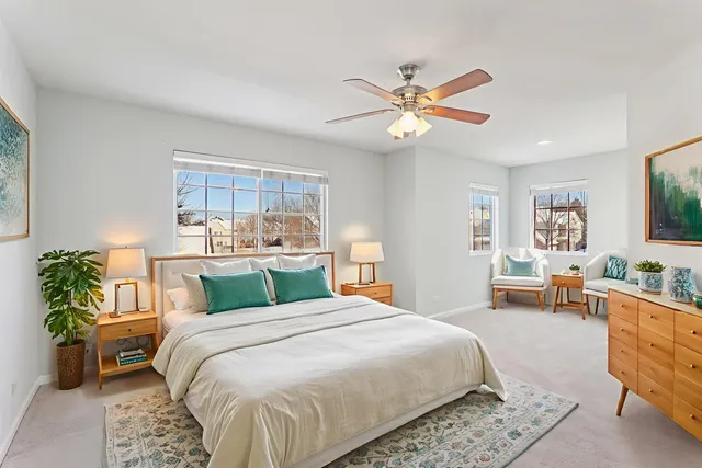 a bedroom with a large bed and a chandelier