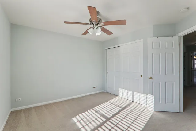 a bedroom with a bed and a ceiling fan