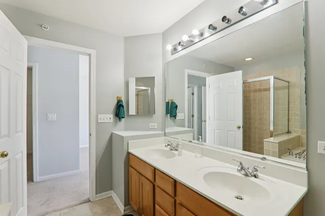 a bathroom with a double vanity sink and mirror