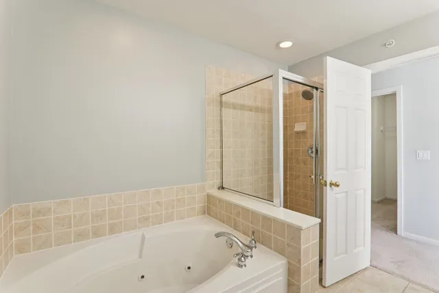 a bathroom with a bathtub and a shower