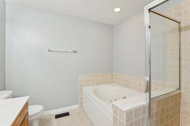 a bathroom with a tub and toilet