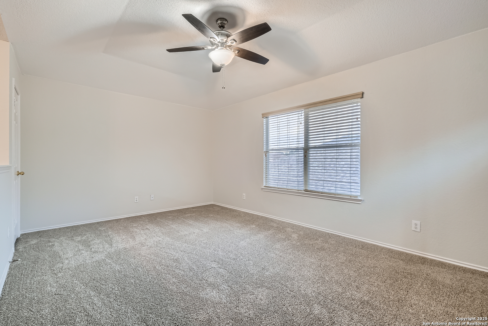 431 Woodstone Loop Cibolo, TX 78108 - Photo 11 of 29 an empty room with a window and a fan