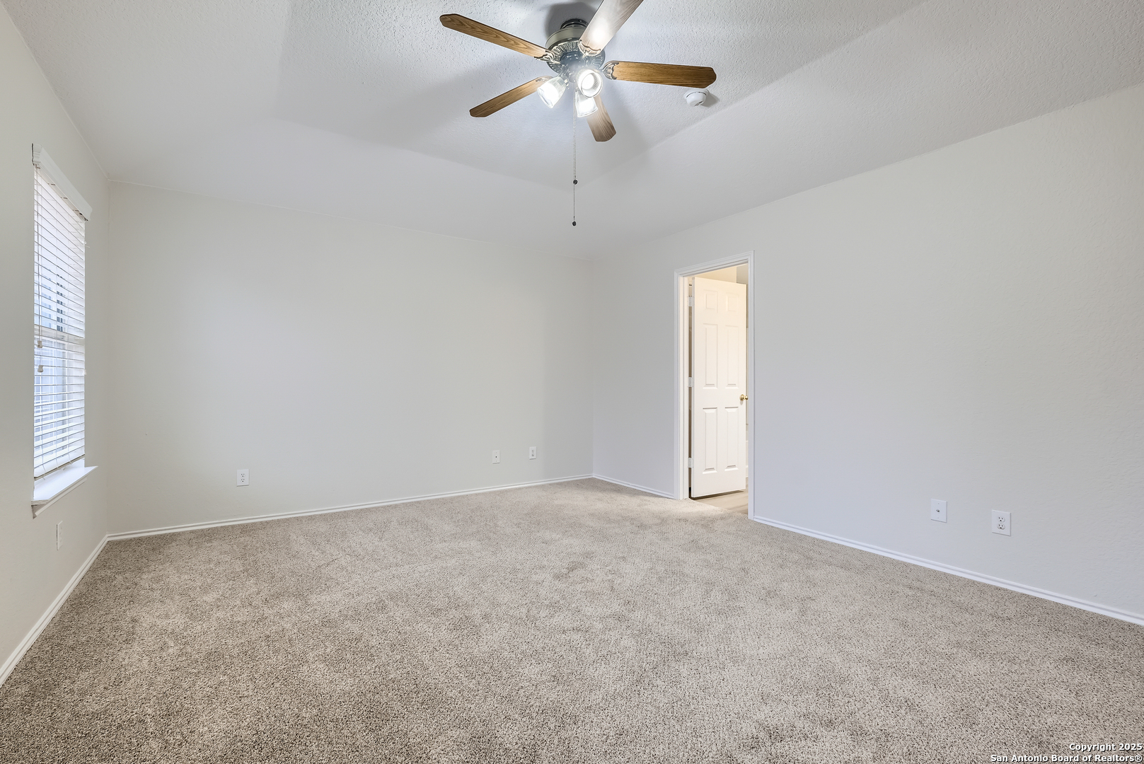 431 Woodstone Loop Cibolo, TX 78108 - Photo 13 of 29 an empty room with a window and a fan