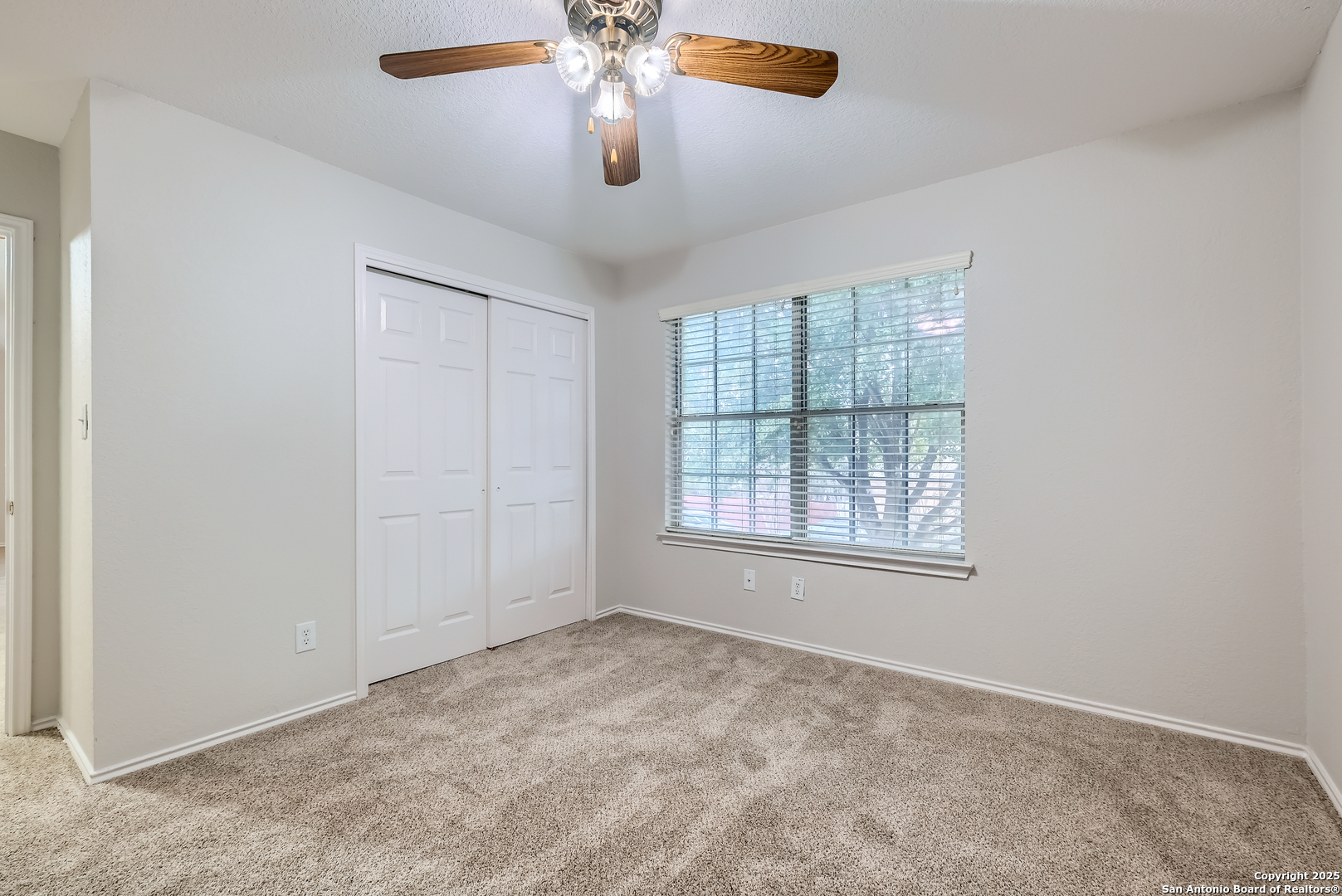 431 Woodstone Loop Cibolo, TX 78108 - Photo 15 of 29 an empty room with windows and fan