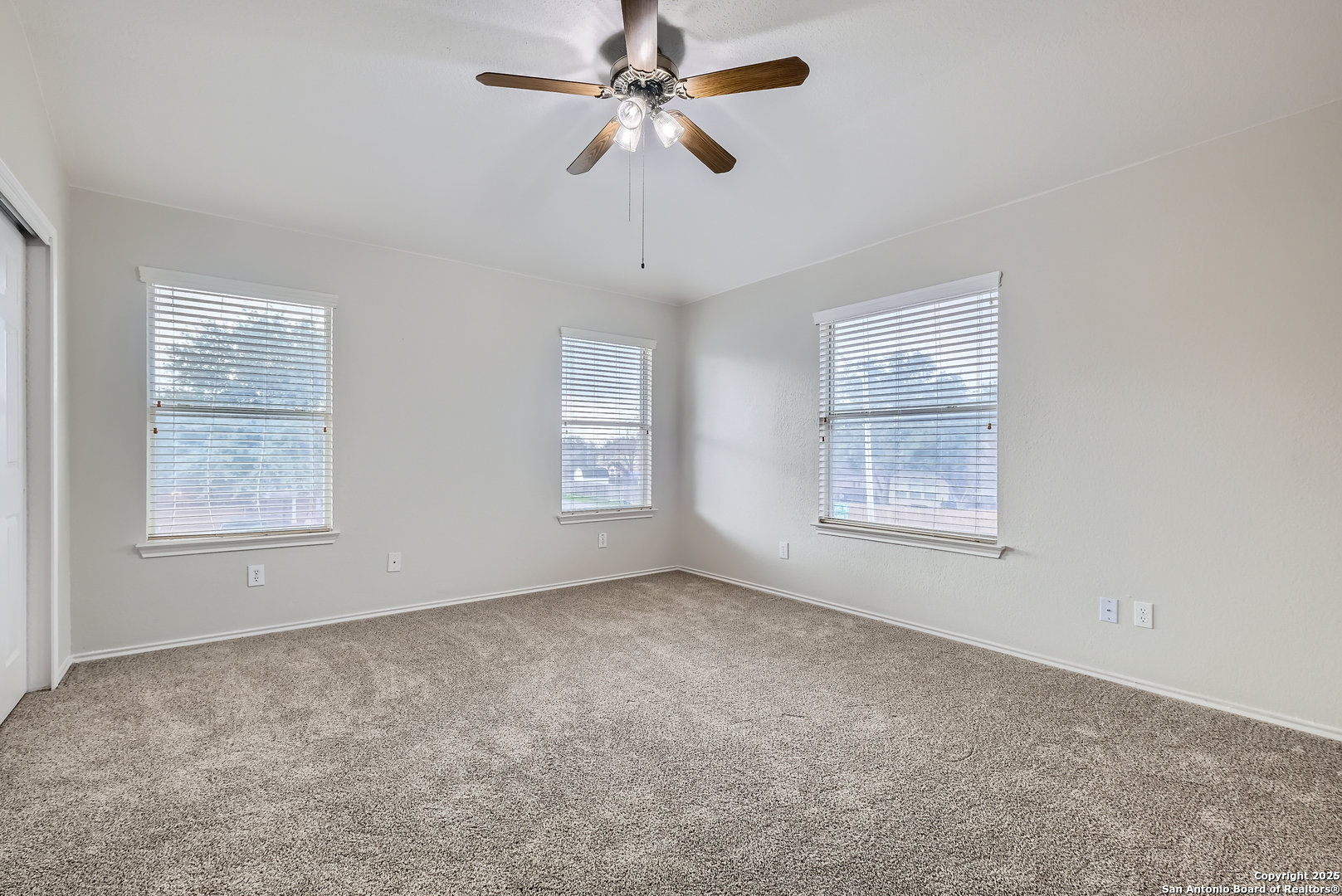 431 Woodstone Loop Cibolo, TX 78108 - Photo 18 of 29 an empty room with windows and fan