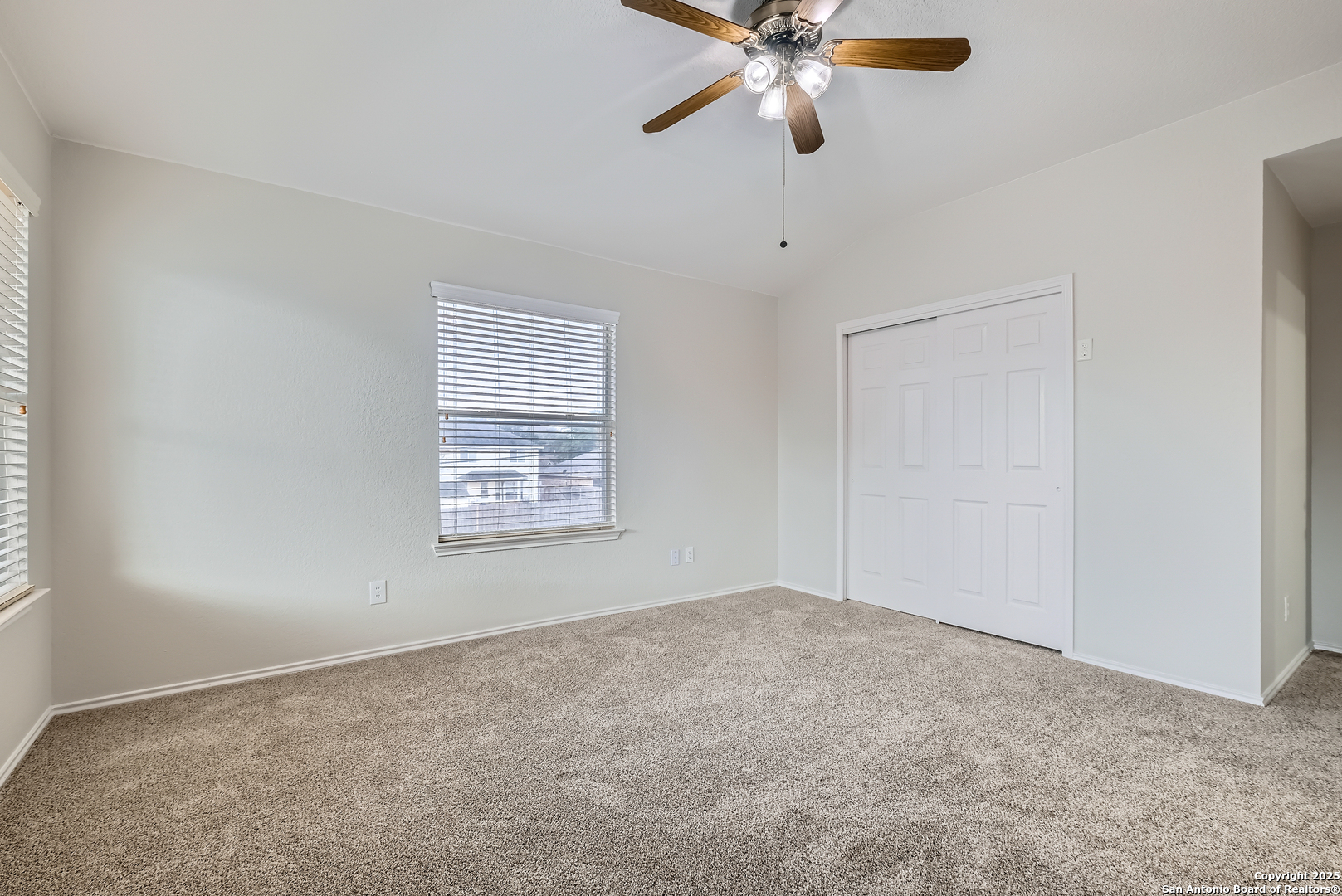 431 Woodstone Loop Cibolo, TX 78108 - Photo 20 of 29 an empty room with windows and fan