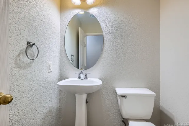 a view of a house with a door and wooden fence