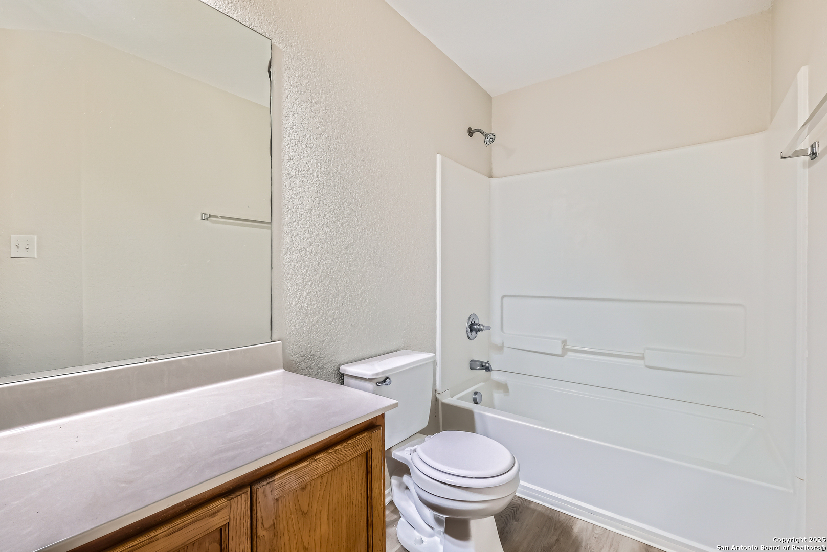 431 Woodstone Loop Cibolo, TX 78108 - Photo 23 of 29 a bathroom with a granite countertop sink toilet and shower