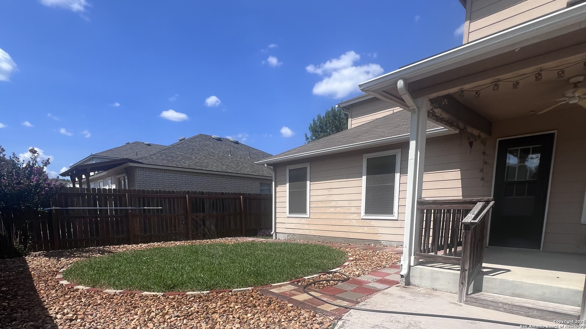 431 Woodstone Loop Cibolo, TX 78108 - Photo 25 of 29 a view of a house with a door and wooden fence