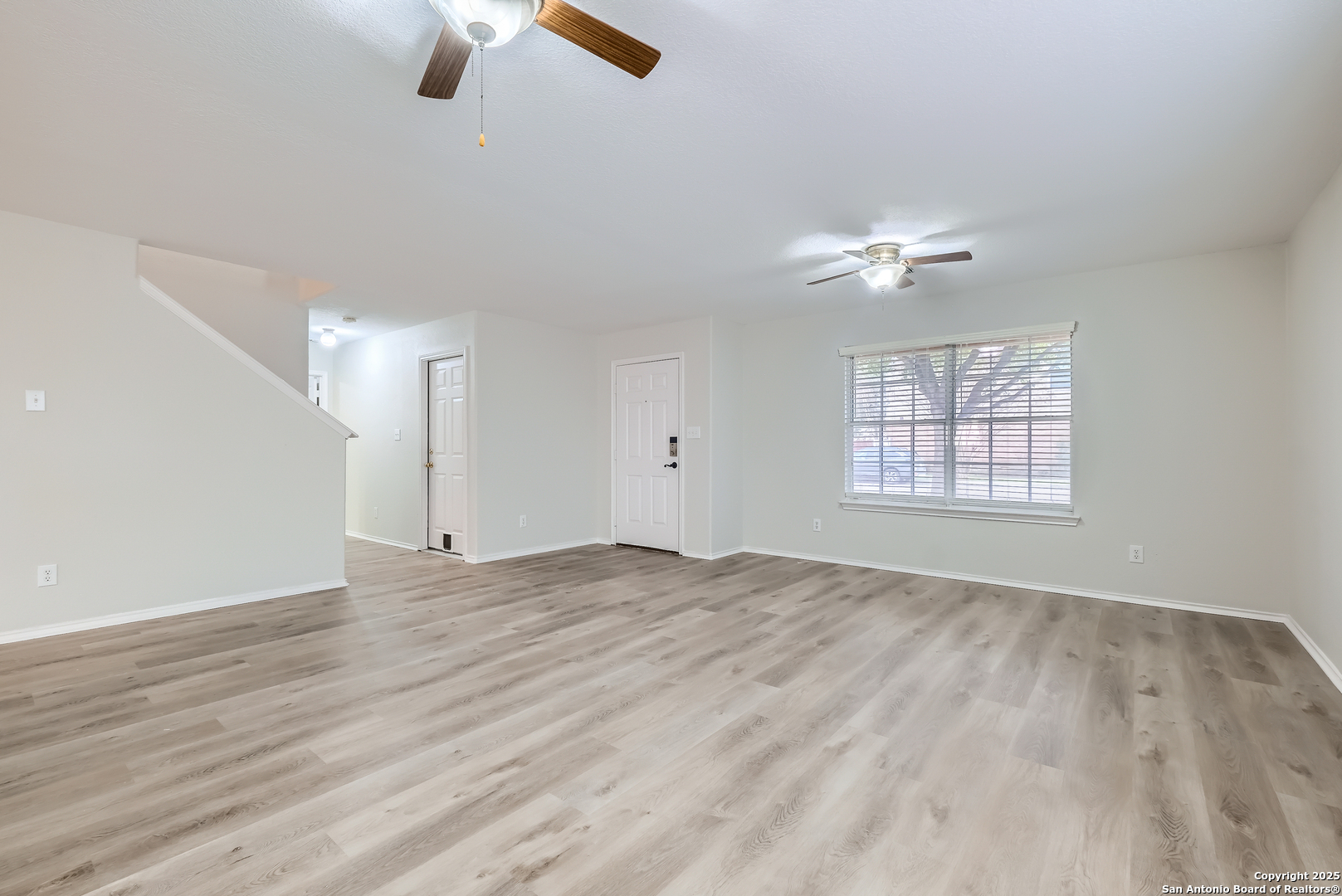 431 Woodstone Loop Cibolo, TX 78108 - Photo 9 of 29 wooden floor in an empty room with a window