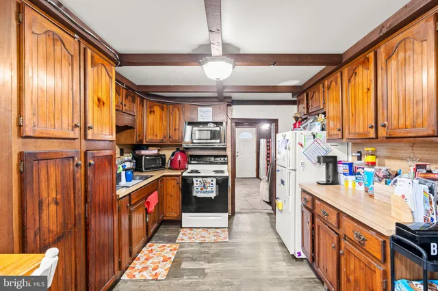 a kitchen with stainless steel appliances granite countertop a refrigerator and a stove