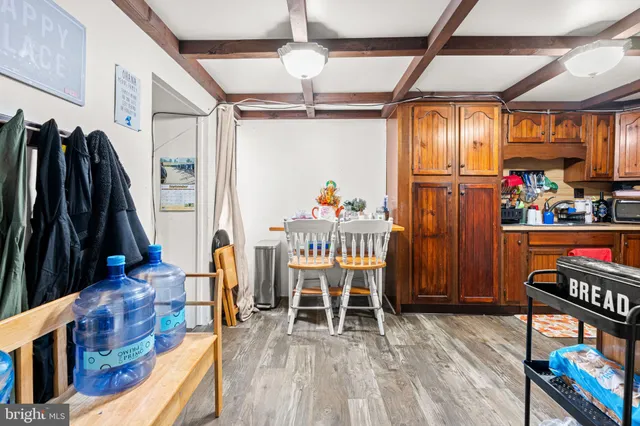 a dining room with furniture a rug and wooden floor