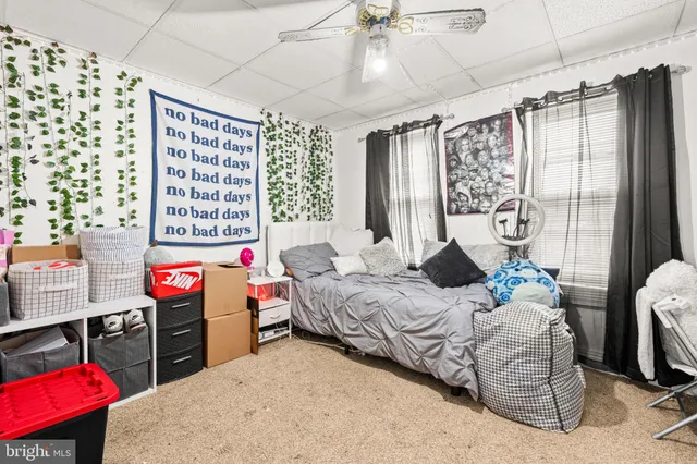 a bedroom with bed and a large window
