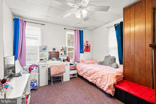 a bedroom with bed and a chandelier