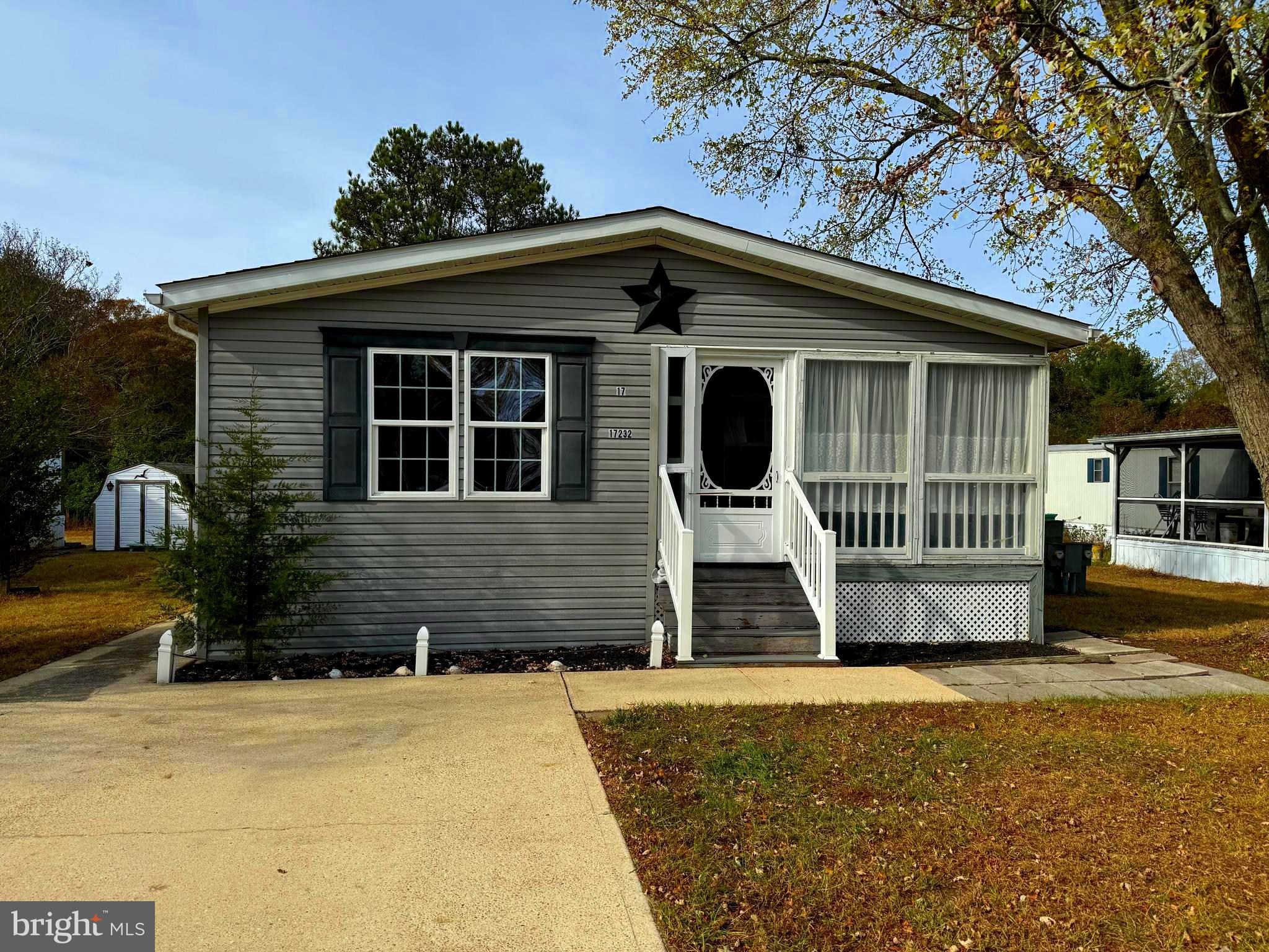 17232 Pine Water Drive, Unit 51946 Lewes, DE 19958 - Photo 1 of 23 a front view of a house with a yard