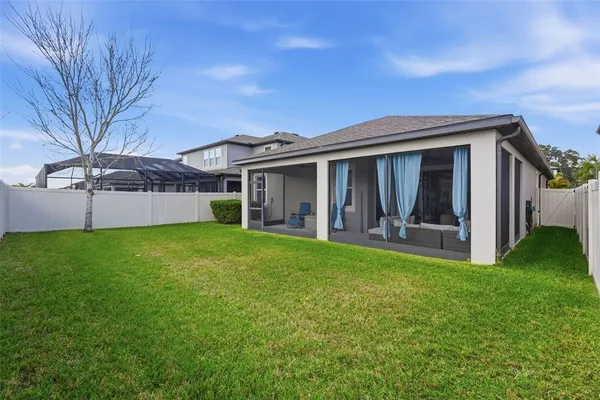 a view of a house with a backyard