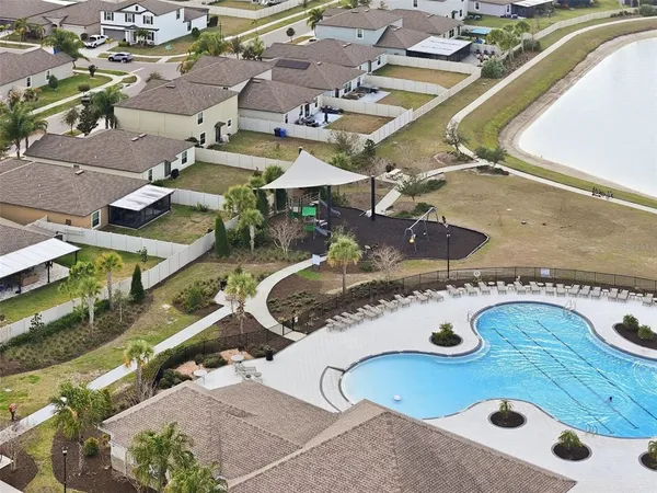 an aerial view of a house with yard