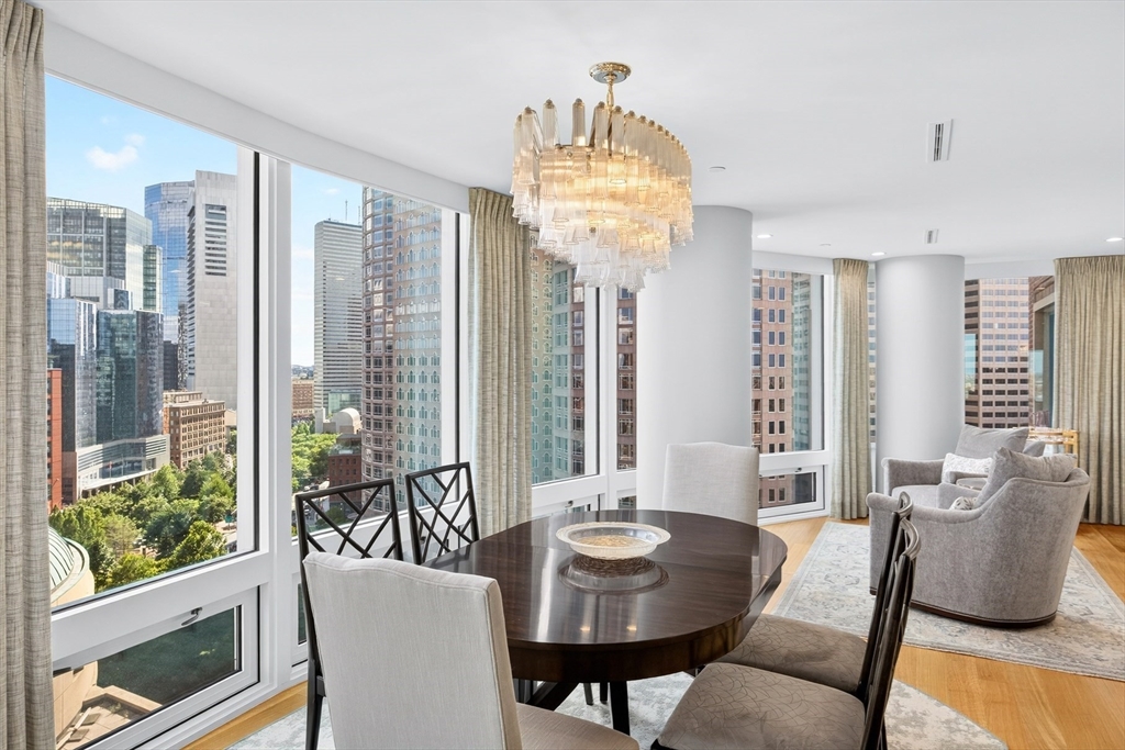 10 Rowes Wharf, Unit PH4 Boston, MA 02110 - Photo 13 of 42 a view of a dining room with furniture wooden floor and chandelier