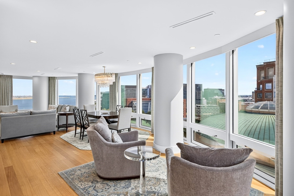 10 Rowes Wharf, Unit PH4 Boston, MA 02110 - Photo 22 of 42 a living room with furniture and a potted plant