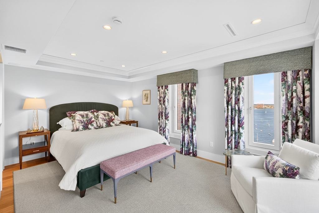 10 Rowes Wharf, Unit PH4 Boston, MA 02110 - Photo 24 of 42 a bedroom with a bed and a couch