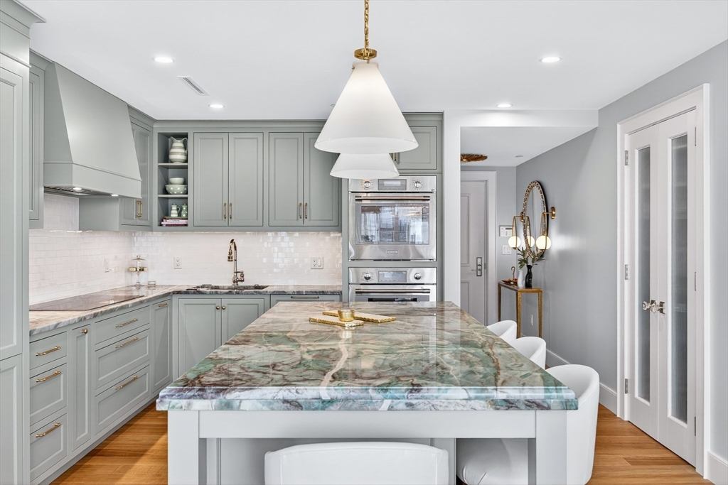 10 Rowes Wharf, Unit PH4 Boston, MA 02110 - Photo 10 of 42 a kitchen with stainless steel appliances granite countertop a sink stove and refrigerator