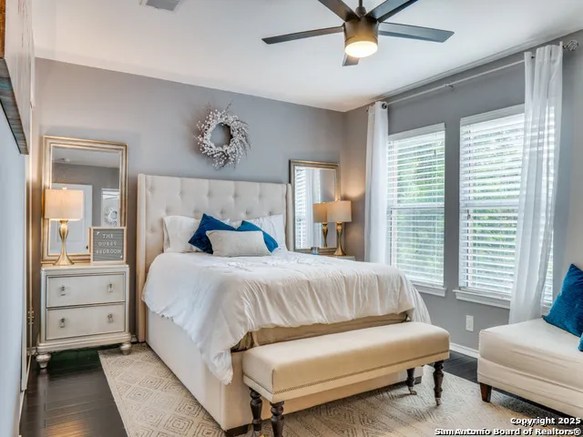 a bedroom with a bed couches and window