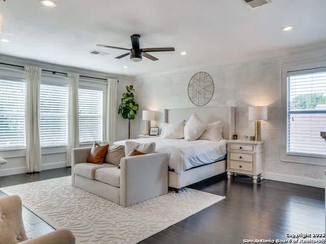 a bedroom with furniture and a large window