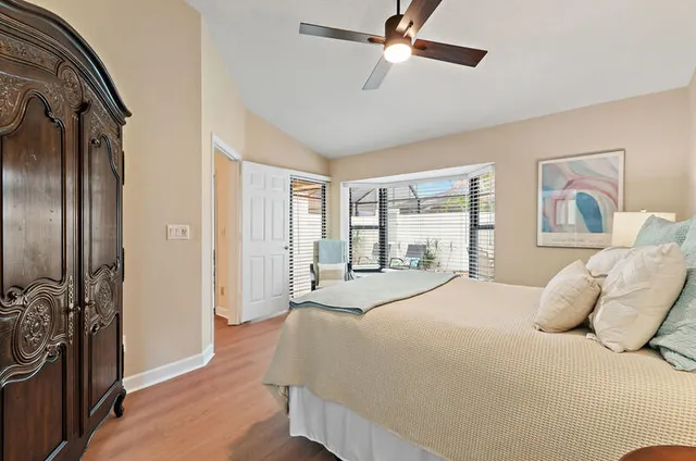 a bedroom with a large bed and a chandelier