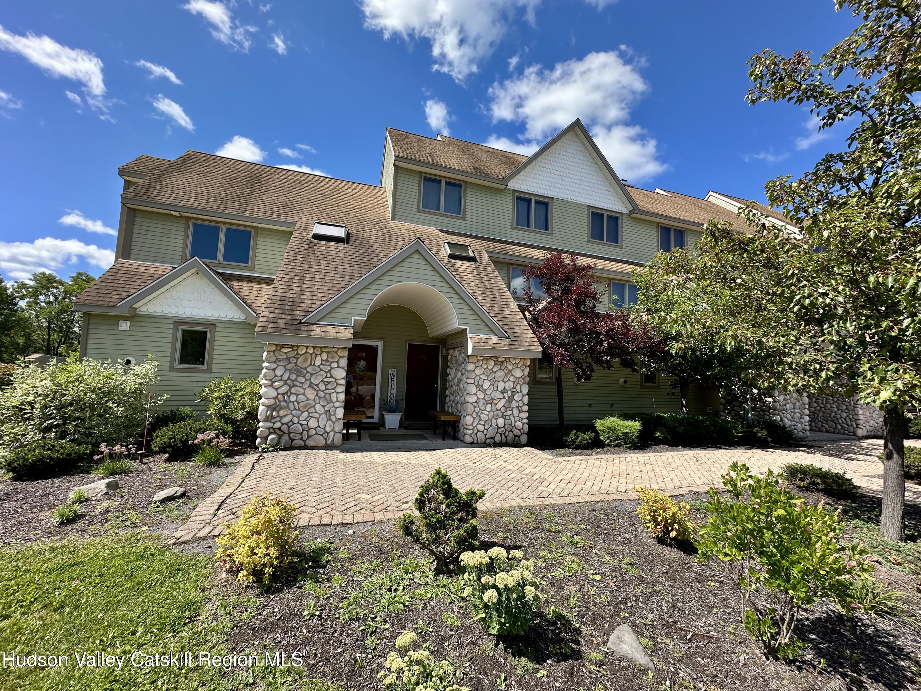 274 Brooksburgh Road, Unit 67 Hensonville, NY 12439 - Photo 1 of 36 a front view of a house with a yard