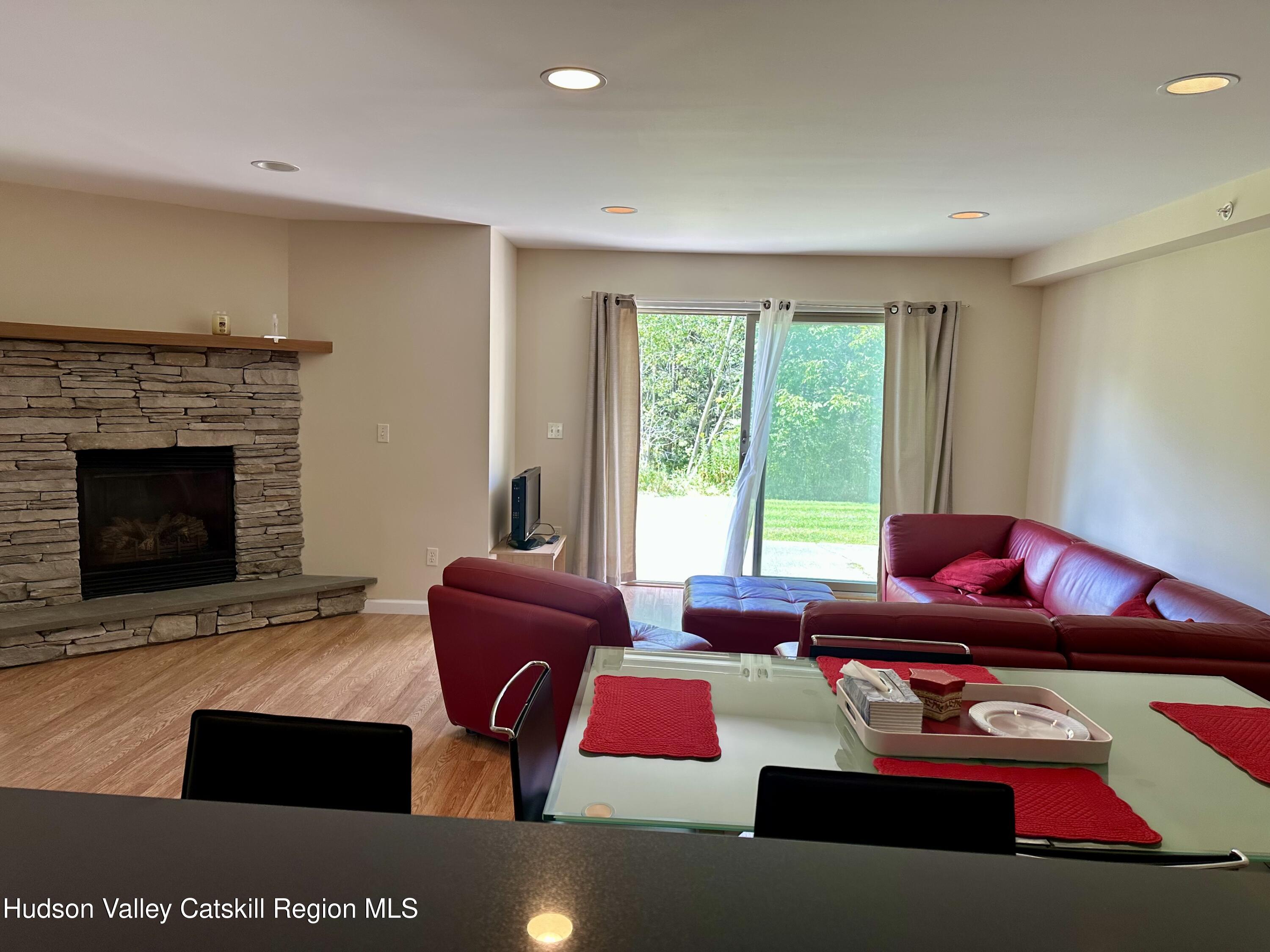 274 Brooksburgh Road, Unit 67 Hensonville, NY 12439 - Photo 14 of 36 a living room with furniture and a fireplace
