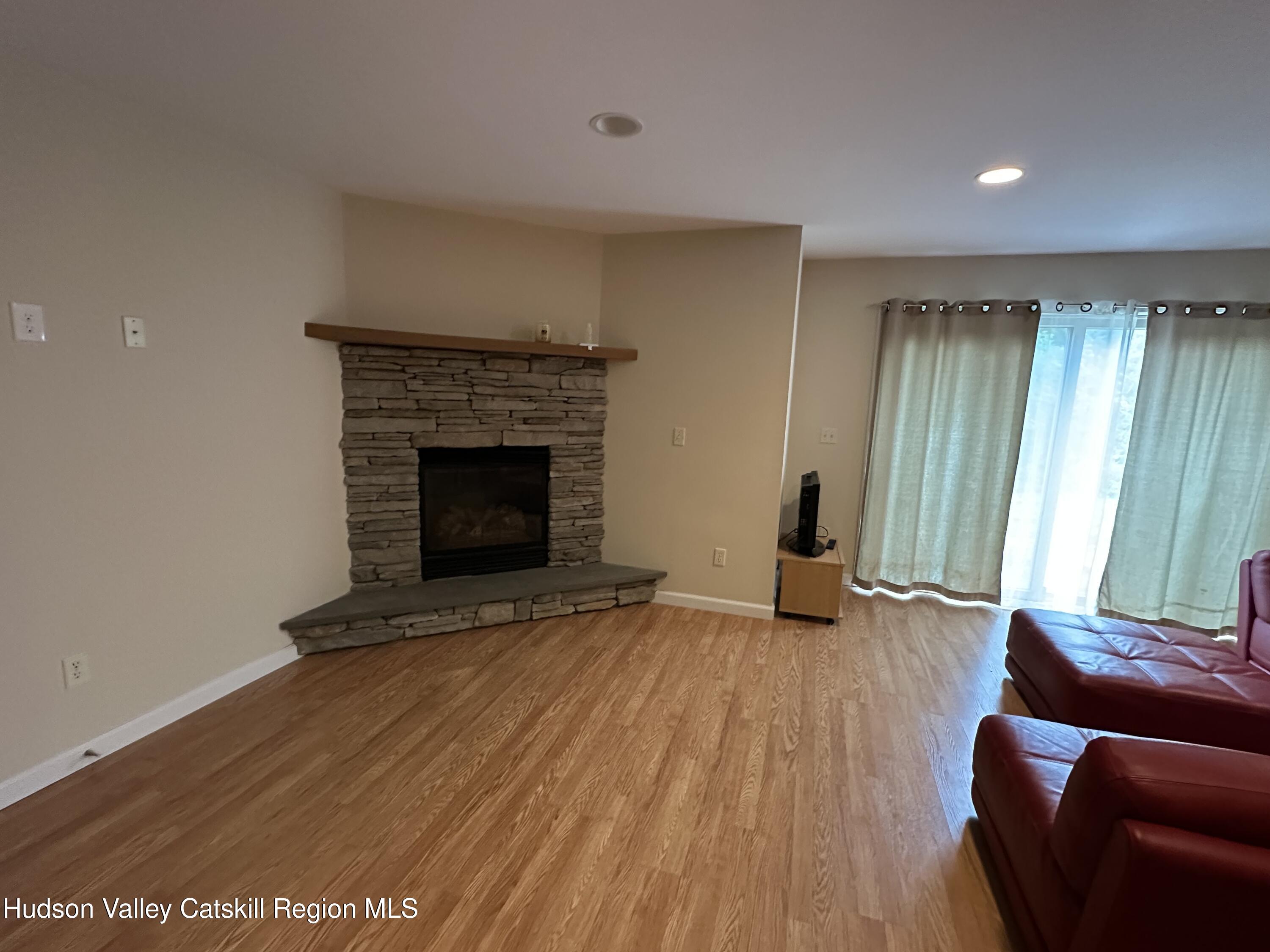 274 Brooksburgh Road, Unit 67 Hensonville, NY 12439 - Photo 16 of 36 a living room with furniture and a fireplace