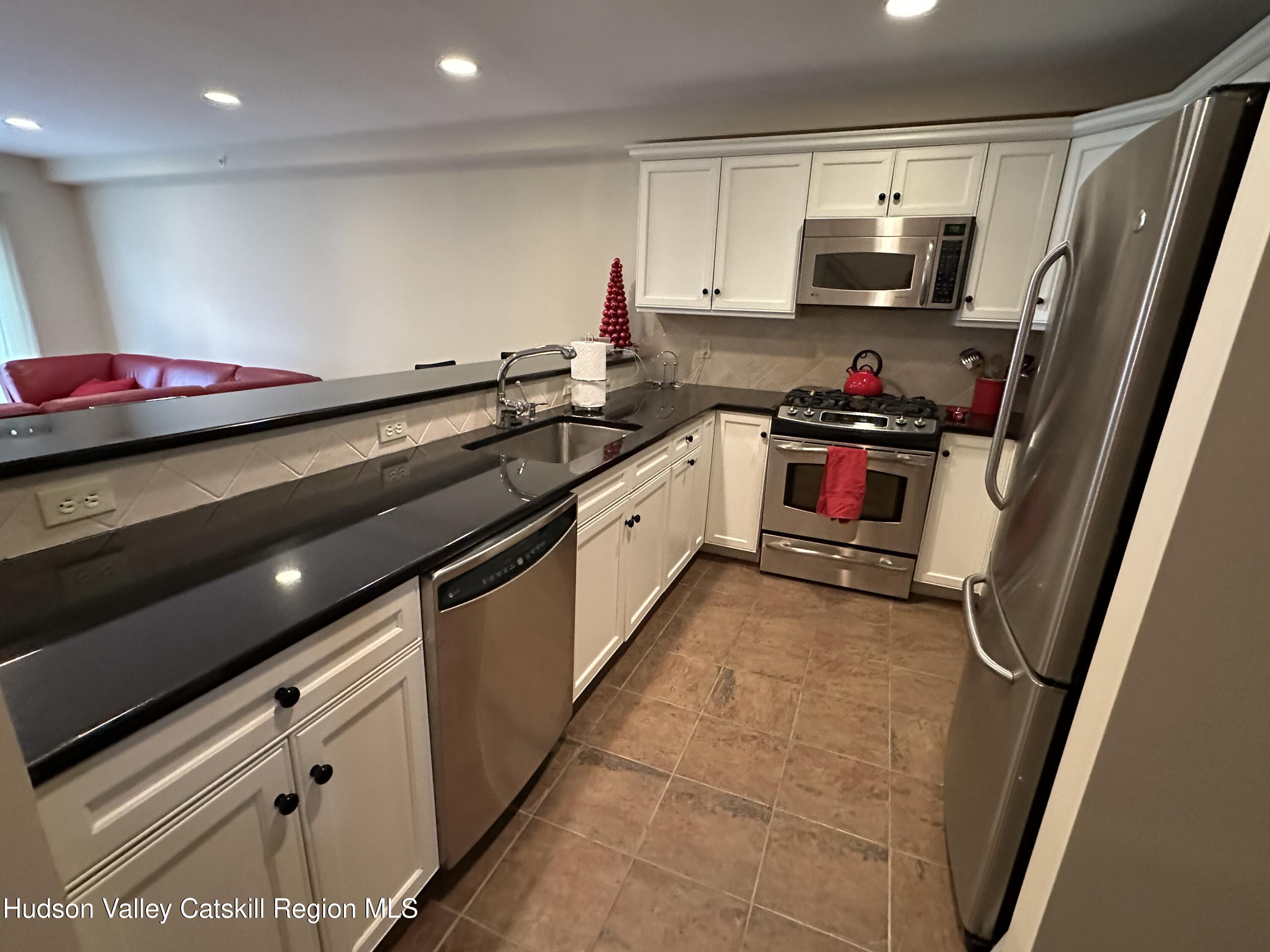 274 Brooksburgh Road, Unit 67 Hensonville, NY 12439 - Photo 18 of 36 a kitchen with granite countertop a sink cabinets and appliances