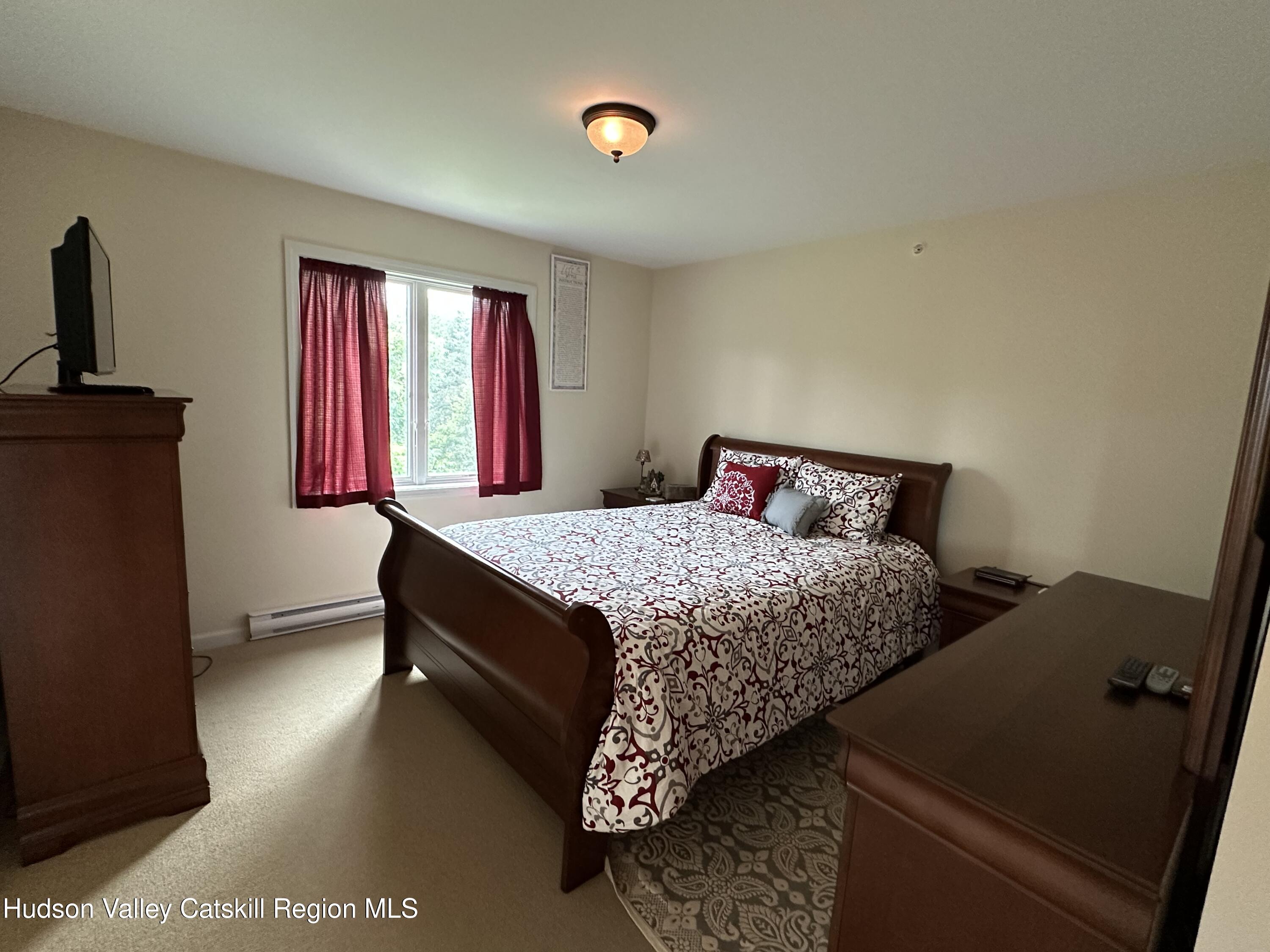 274 Brooksburgh Road, Unit 67 Hensonville, NY 12439 - Photo 21 of 36 a bedroom with a bed and window