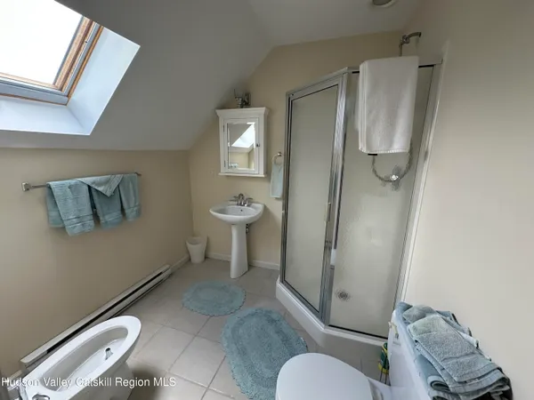 a bedroom with a bed and a mirror on dresser