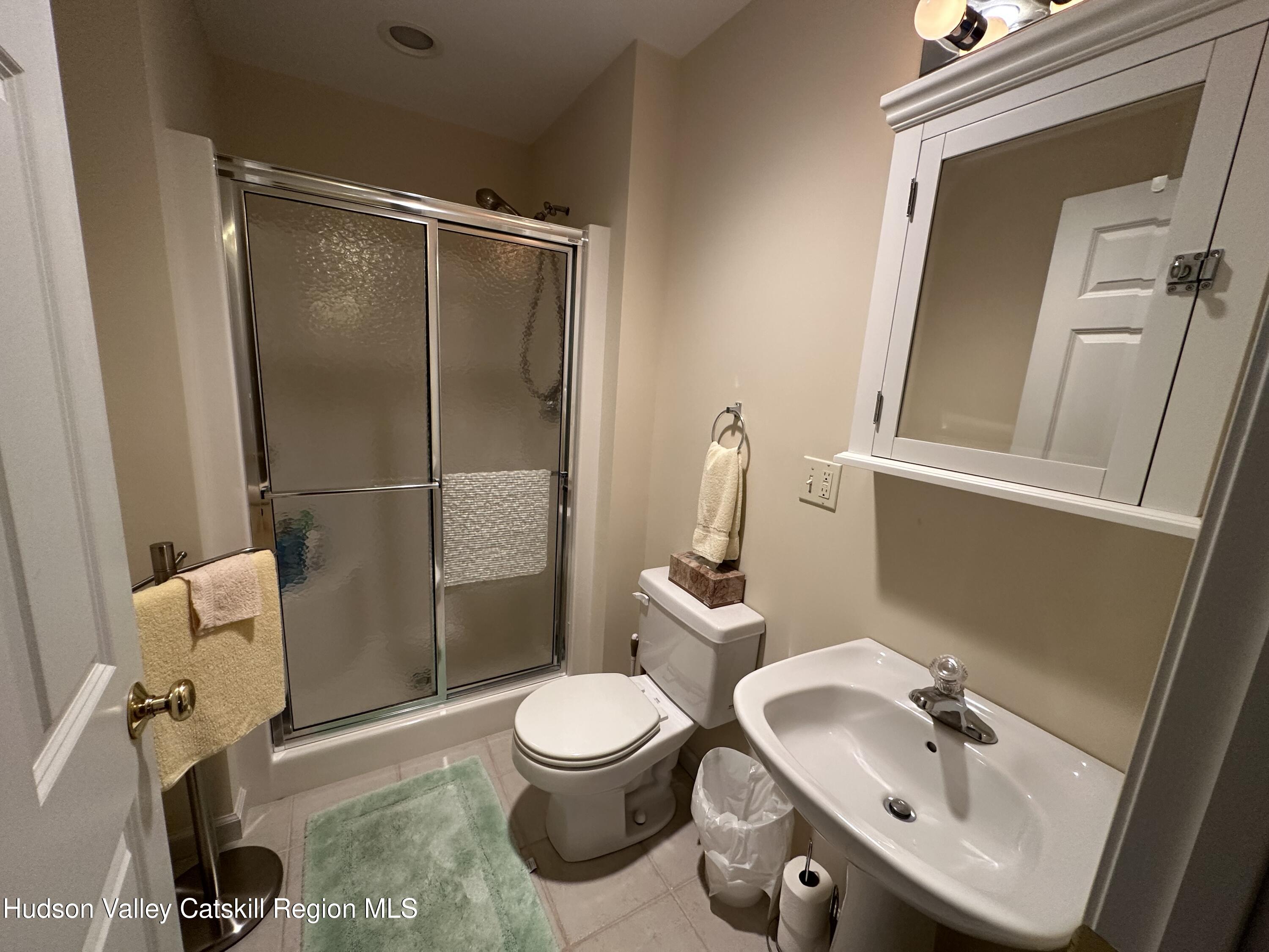 274 Brooksburgh Road, Unit 67 Hensonville, NY 12439 - Photo 27 of 36 a bathroom with a sink mirror vanity and toilet