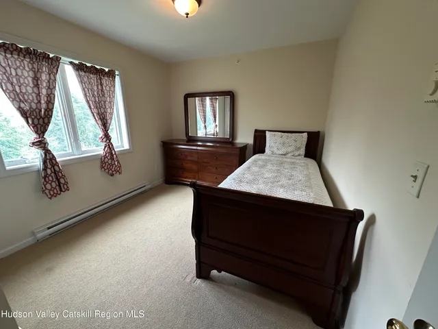 a bedroom with a bed and mirror