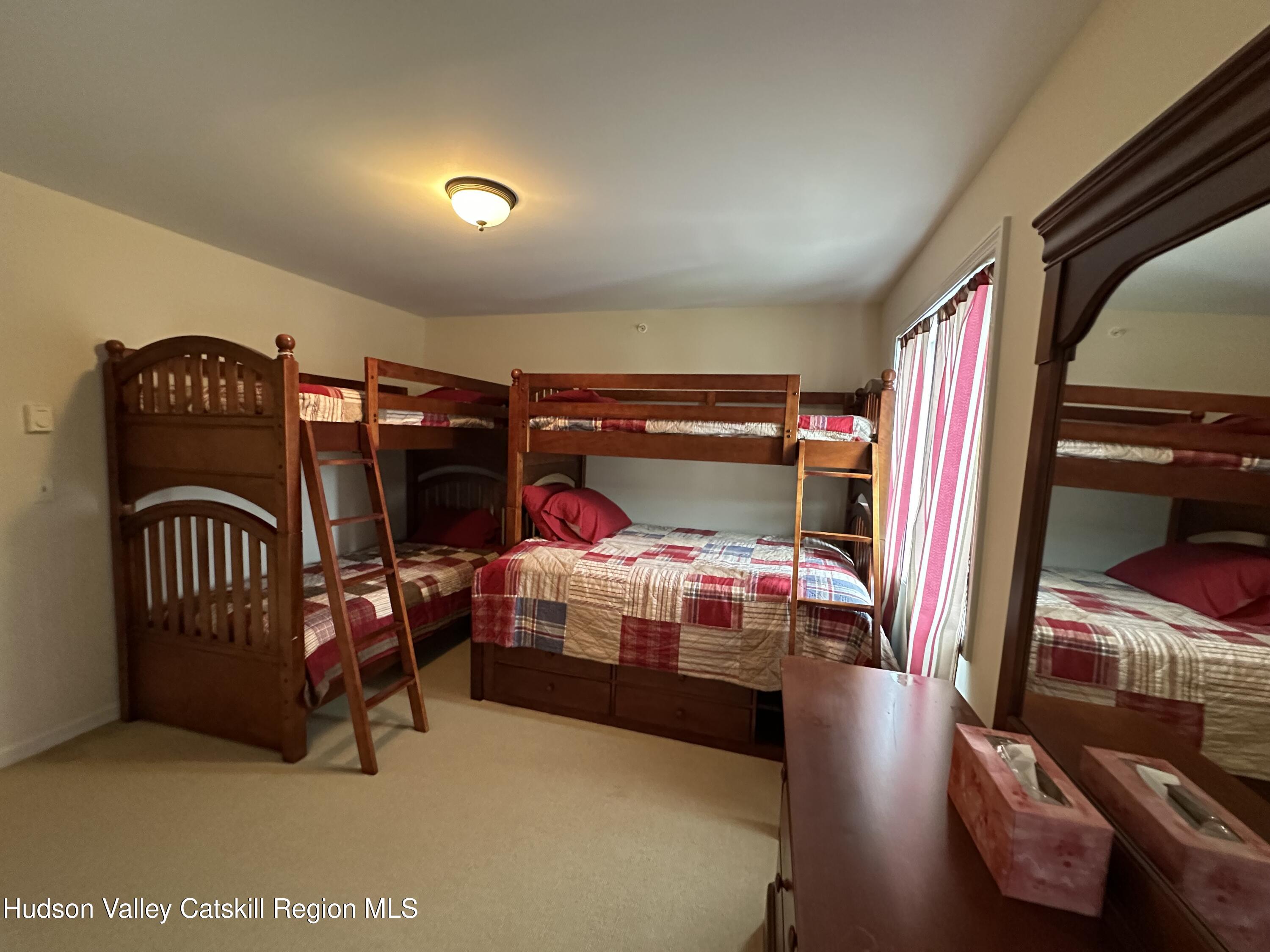 274 Brooksburgh Road, Unit 67 Hensonville, NY 12439 - Photo 30 of 36 a bedroom with two bunk beds and a dresser