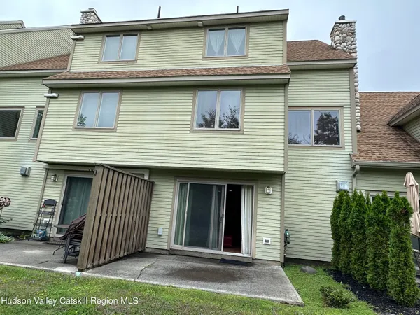 a view of a backyard with sitting area and tub