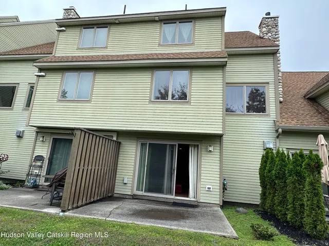 a view of a backyard with sitting area and tub