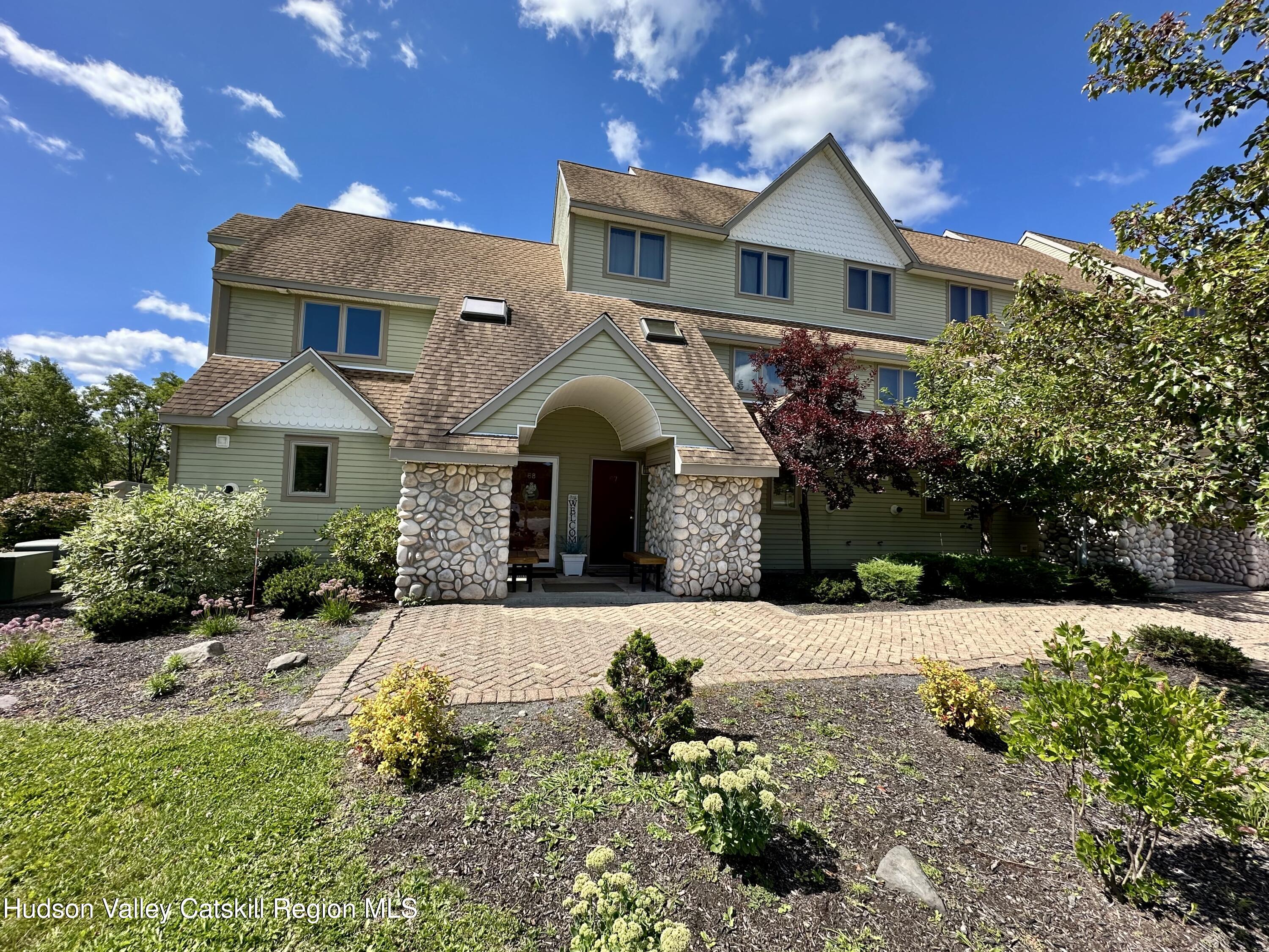 274 Brooksburgh Road, Unit 67 Hensonville, NY 12439 - Photo 36 of 36 a front view of a house with yard garage and outdoor seating