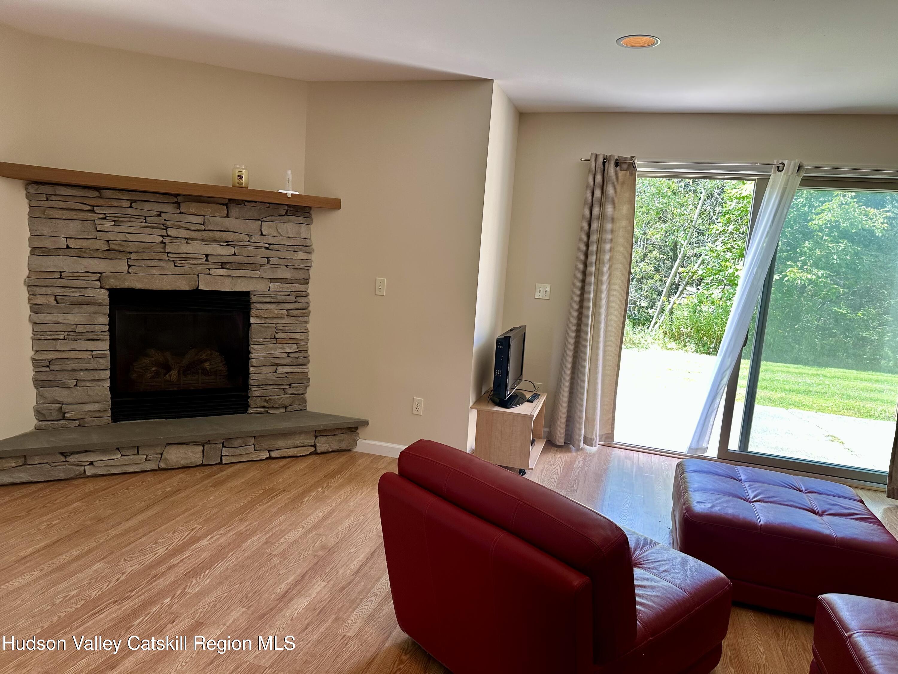 274 Brooksburgh Road, Unit 67 Hensonville, NY 12439 - Photo 7 of 36 a living room with furniture and a fireplace