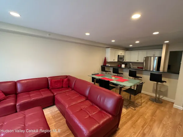 a kitchen with a table chairs and a refrigerator