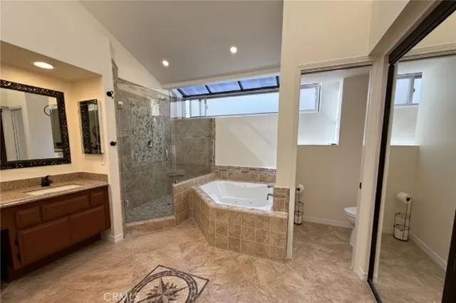 a spacious bathroom with a large tub shower and sink